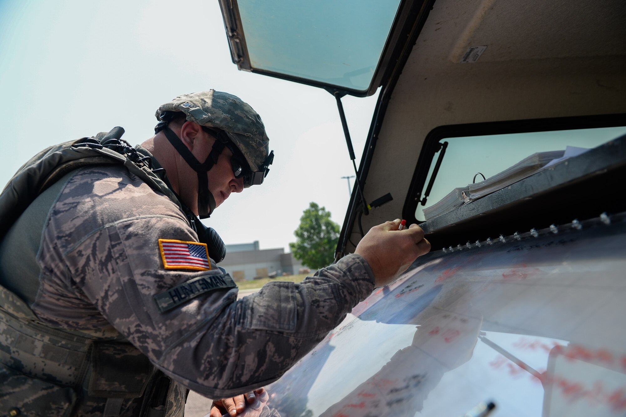 Tech. Sgt. Kelly Huntsman, 50th Security Forces Squadron, updates a base map to implement a cordon at Schriever Air Force Base, Colorado, Thursday, June 16, 2016. The squadron played a crucial role in implementing security measures during different phases of the exercise scenarios. (U.S. Air Force photo/Christopher DeWitt)