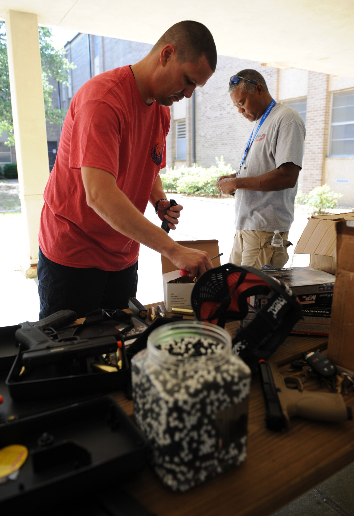 Officer Thomas Snyder, Biloxi Police Department patrolman, and Officer Raymond Brooks, Gulfport Police Department school resource officer and Southeastern Law Enforcement Explorers Academy director, prepare air soft guns for an active shooter training session with Junior ROTC cadets at the Locker House during the Southeastern Law Enforcement Explorers Academy June 17, 2016, Keesler Air Force Base, Miss. The academy offers adolescents the opportunity to gain experience, knowledge, and learn skills necessary to apply for future careers in law enforcement. (U.S. Air Force Photo by Kemberly Groue)

