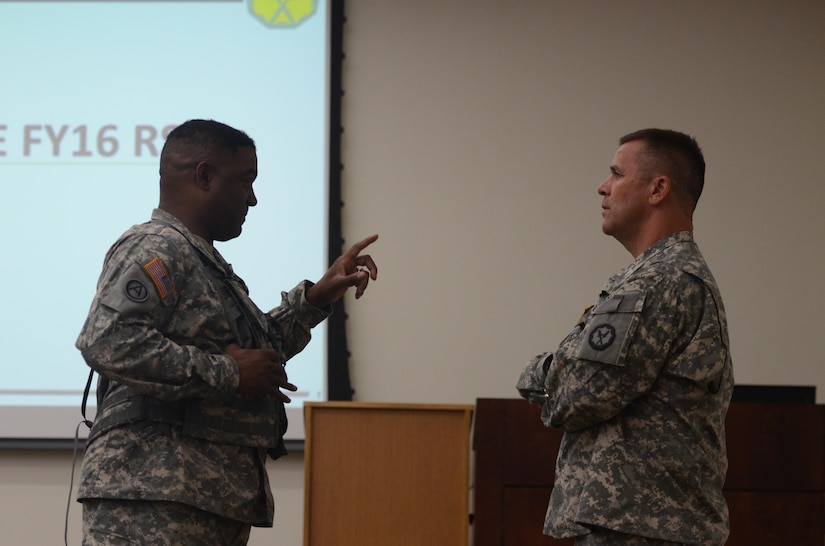 Lt. Col. Sean S. Brown (left), commander of the 724th Military Police Battalion, and Lt. Col. Robert Merry (right), the deputy commanding officer of 290th Military Police Brigade, both with the U.S. Army Reserve, talk before a briefing on exercise Guardian Justice at Fort McCoy, Wisc., June 20, 2016. Guardian Justice is a military police exercise that focuses on detention operations and combat support. (U.S. Army photo by Spc. Adam Parent)