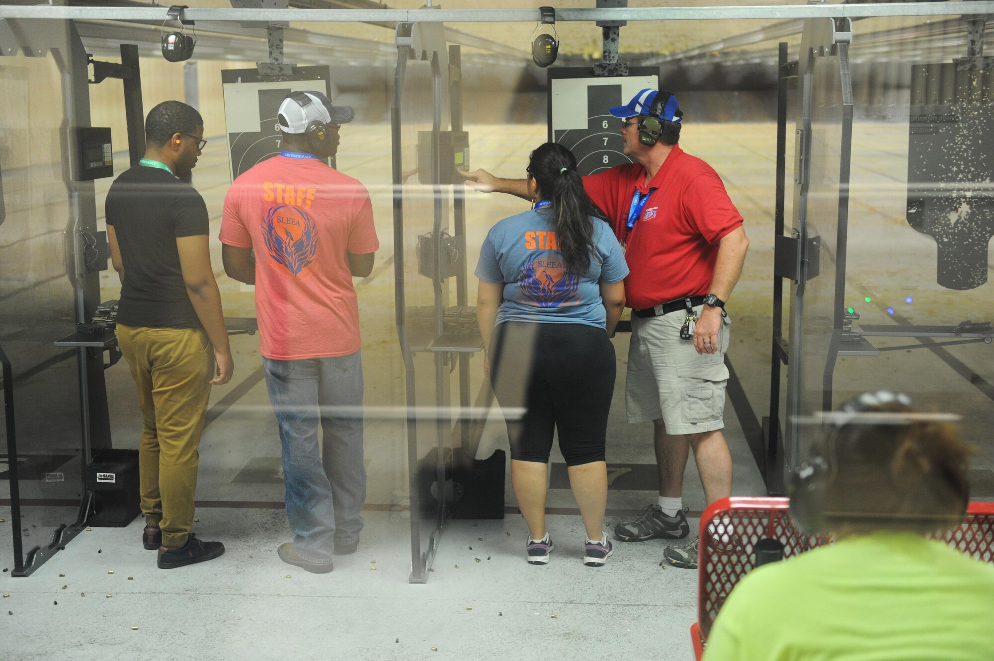 Junior ROTC cadets receive weapons instruction from local police officers at the 81st Security Forces Squadron indoor firing range during the Southeastern Law Enforcement Explorers Academy June 17, 2016, Keesler Air Force Base, Miss. The academy offers adolescents the opportunity to gain experience, knowledge, and learn skills necessary to apply for future careers in law enforcement. (U.S. Air Force Photo by Kemberly Groue)