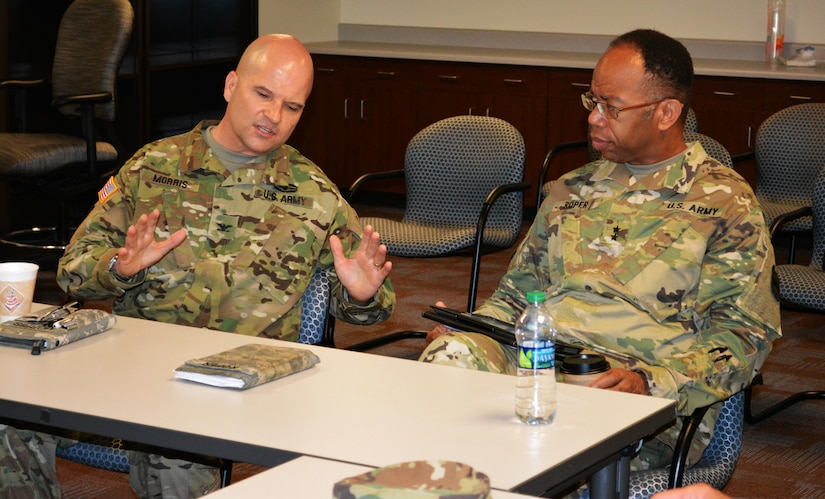 Col. Albert Morris, commander 5th Brigade 94th Training Division, discusses the state of the brigade with Maj. Gen. A.C. Roper, commander of the 80th Training Command, at Fort Allen, Puerto Rico, March 11, 2016. Fifth Brigade offers reclassification training in 10 Military Occupational Specialties and 12 Non-Commissioned Officer Education System courses, in compliance with U.S. Army Training and Doctrine Command accreditation standards. The multifunctional Army Reserve unit is also the only MOS qualification brigade in the Army Reserve that is 100 percent bilingual.