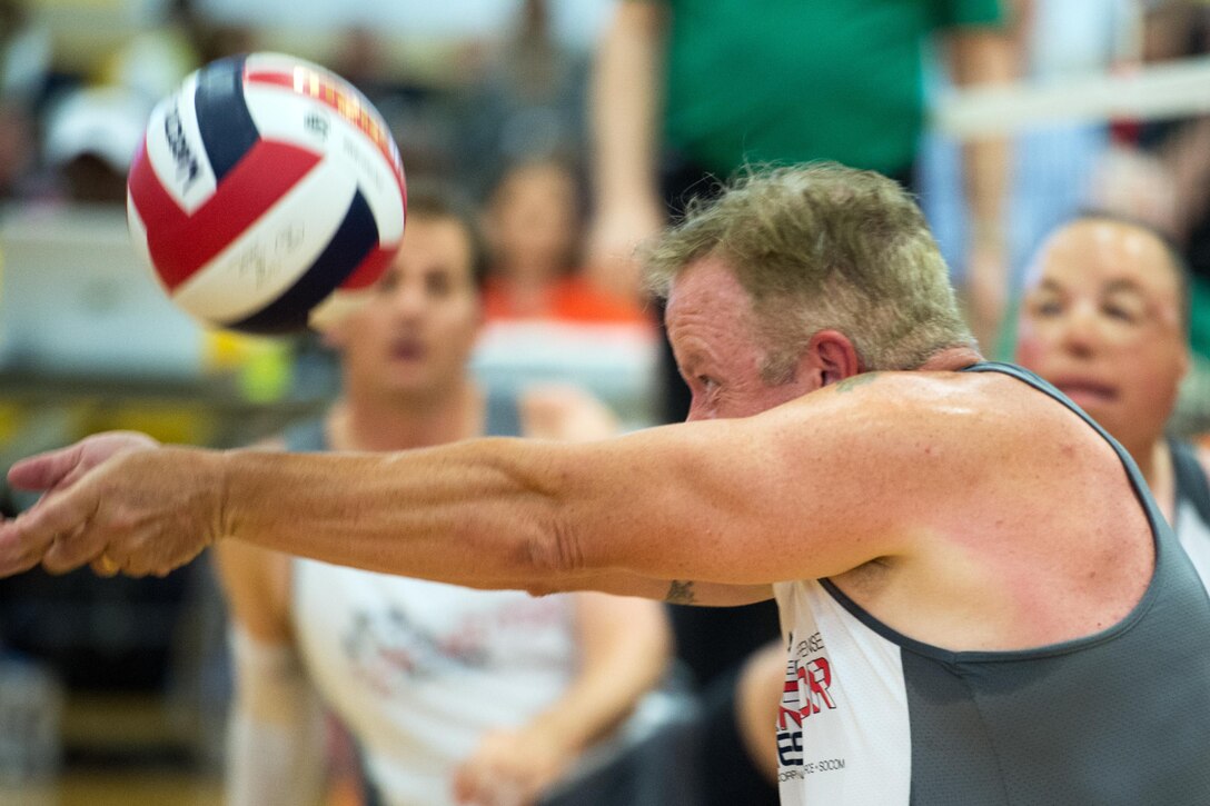 Army veteran Edward O’Neil, a member of the U.S. Special Operations Command team, returns a ball during the sitting volleyball gold medal match of the 2016 Department of Defense Warrior Games at the U.S. Military Academy in West Point, N.Y., June 21, 2016. DoD photo by EJ Hersom