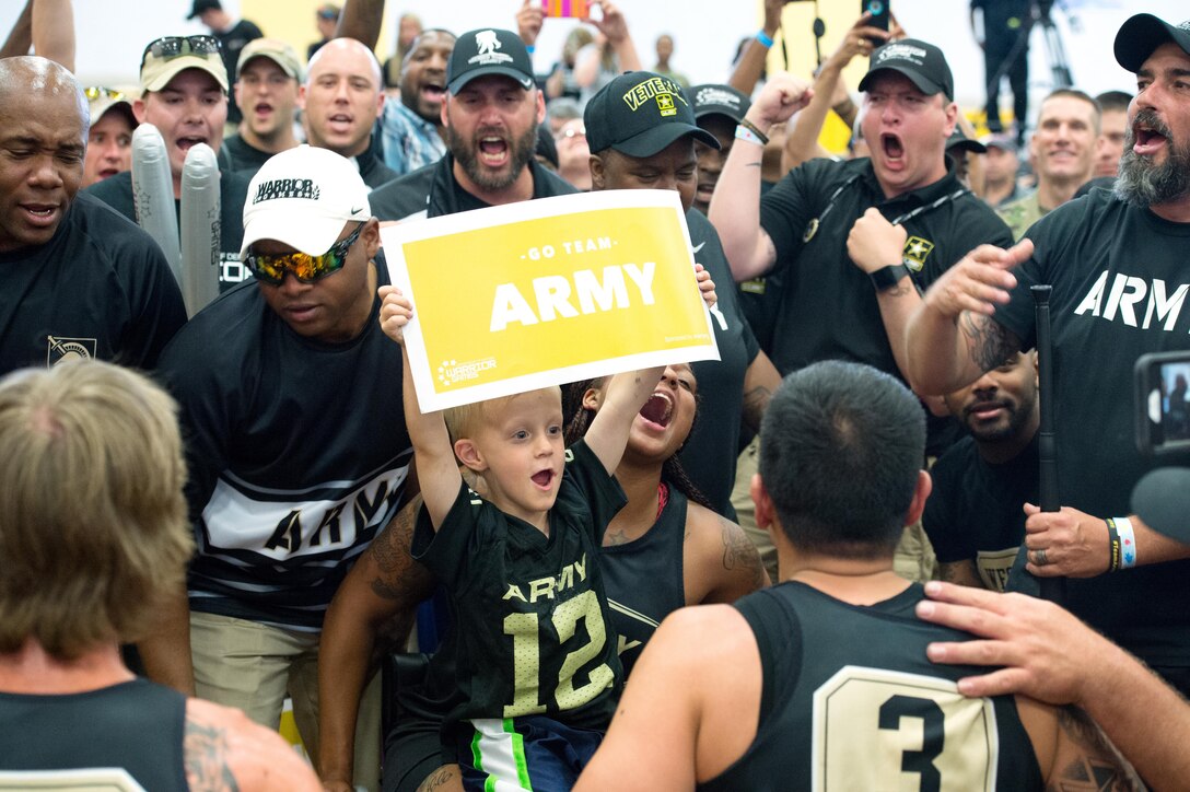 Timothy Berg, 5, center, celebrates with Army team members after they won the gold medal in basketball during the 2016 Department of Defense Warrior Games at the U.S. Military Academy in West Point, N.Y. June 21, 2016. DoD photo by EJ Hersom