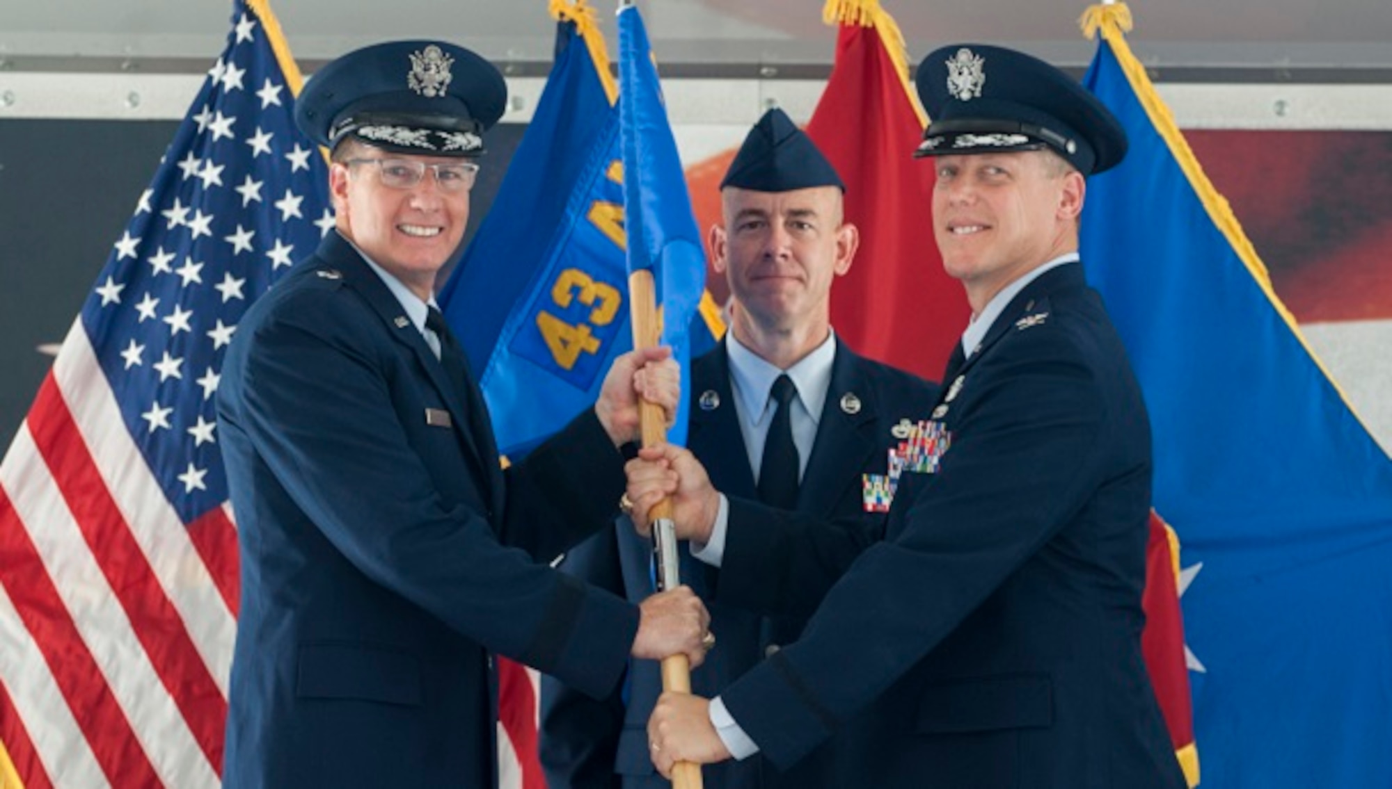 Col. Kelly Holbert accepts the 43d Air Mobility Operations Group guidon from Brig. Gen. James Scanlan during a change-of-command ceremony at Pope Field June 14. Holbert came to Pope from Air Mobility Command headquarters at Scott Air Force Base, Ill, where he served as the chief of the Resource, Requirements and Readiness Division. He took command of the group here, formerly named the 43d Airlift Group, after it was redesignated as the 43d AMOG during the ceremony. General Scanlan is the mobilization assistant to the commander of the U.S. Air Force Expeditionary Center at Joint Base McGuire-Lakehurst, N.J. (U.S. Air Force photo/Marc Barnes)