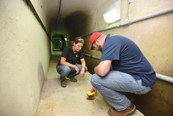 Georgette, Hlepas, senior geotechnical engineer with the Dam Safety Modification and Mandatory Center of Expertise in Huntington, West Va., examines drain holes and uplift cells with a student in the gallery of J. Percy Priest Dam in Nashville, Tenn., June 16, 2016.