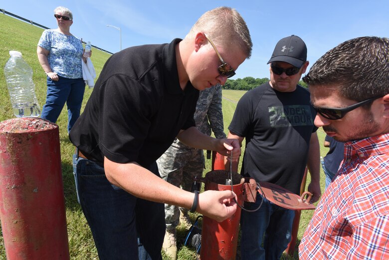 Keith Thole, U.S. Army Corps of Engineers St. Louis District civil engineer, demonstrates reading a manual piezometer with students, including Ed Blackburn, civil engineer in the Nashville District’s Soils and Dam Safety Section.  They were getting hands-on training at J. Percy Priest Dam June 16, 2016.