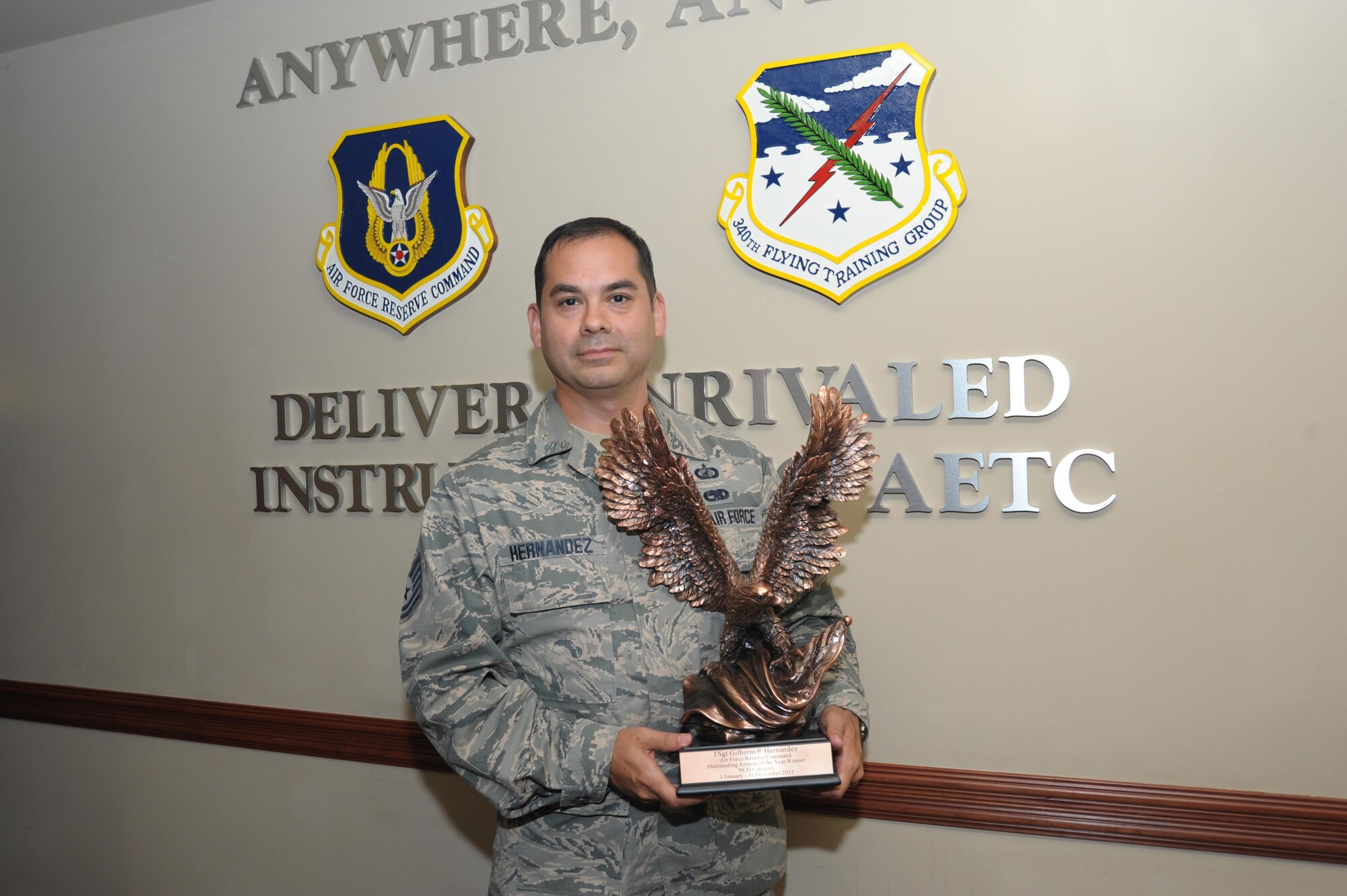Technical Sergeant Gilberto Hernandez, 340th Flying Training Group, non-commissioned officer of the year, poses with his award June 15, at Joint Base San Antonio-Randolph. Hernandez led the processing of more than 25,000 military pay transactions with a 98.6 percent accuracy rate in 2015.