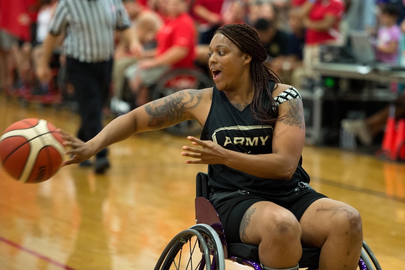 Army Spc. Stephanie Morris passes the ball during the basketball gold medal round of the 2016 Department of Defense Warrior Games at the U.S. Military Academy in West Point, N.Y., June 21, 2016. DoD photo by EJ Hersom