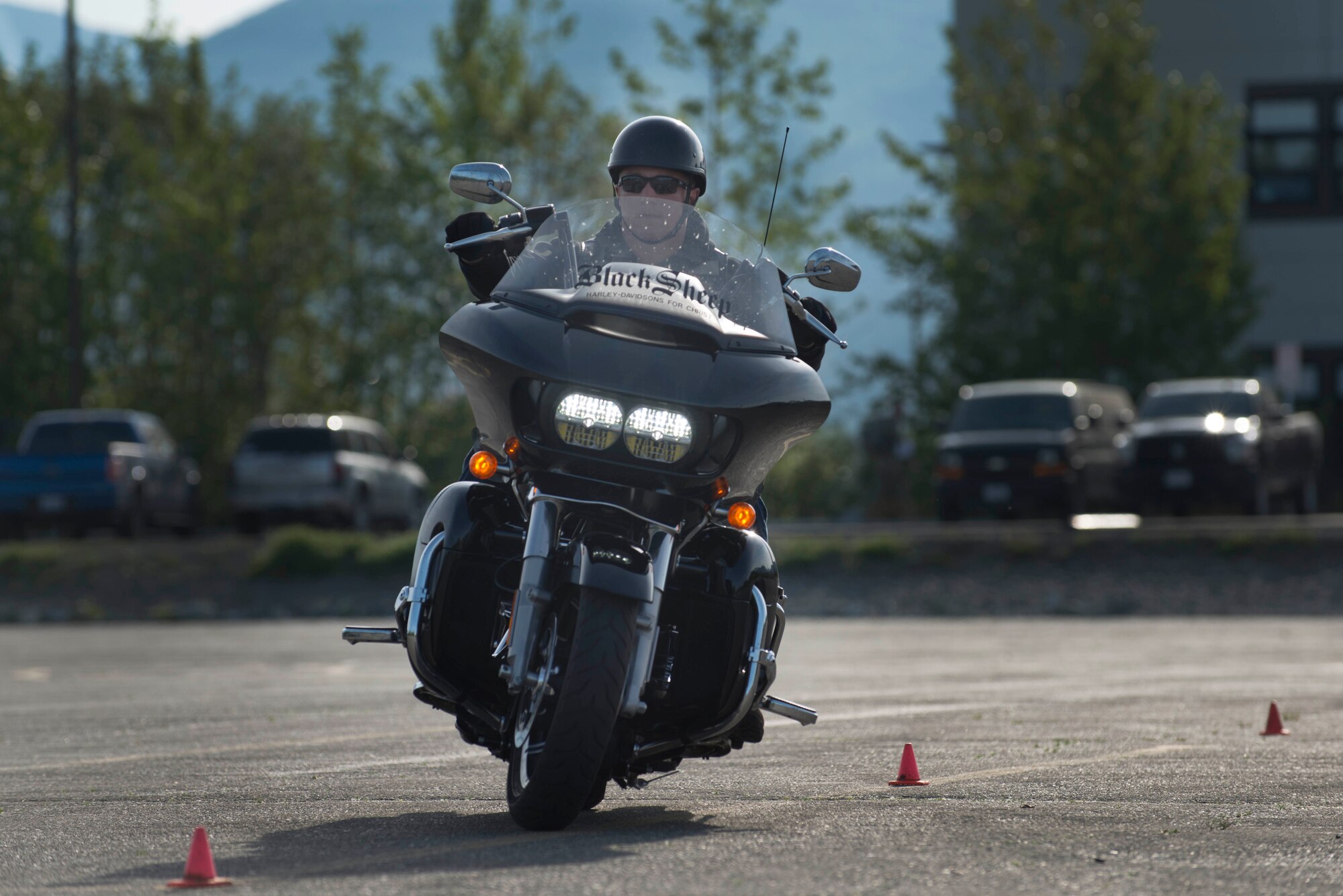 A motorcyclist swerves between cones during a pre-ride skills assessment at Joint Base Elmendorf-Richardson, Alaska. At JBER, the riding season typically runs from May to October and motorcycle operations are only allowed when road conditions are green. (U.S. Air Force photo by Senior Airman Kyle Johnson)
