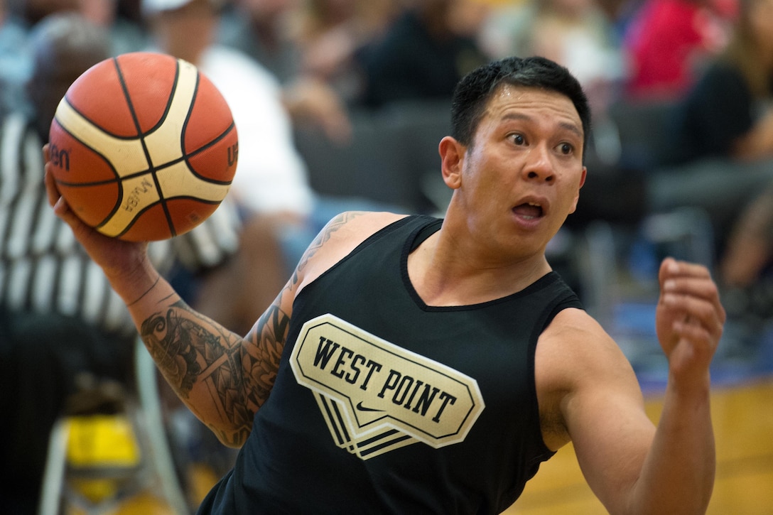 Army veteran Jhoonar Barrera looks to pass the ball during the basketball gold medal round of the 2016 Department of Defense Warrior Games at the U.S. Military Academy in West Point, N.Y., June 21, 2016. DoD photo by EJ Hersom