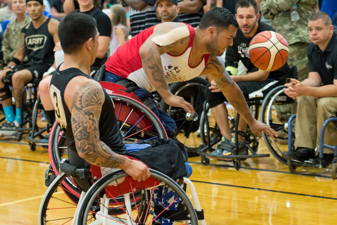 Marine Corps veteran Jorge Salazar tips his wheelchair while fighting for a ball during the basketball gold medal round of the 2016 Department of Defense Warrior Games at the U.S. Military Academy in West Point, N.Y., June 21, 2016. DoD photo by EJ Hersom