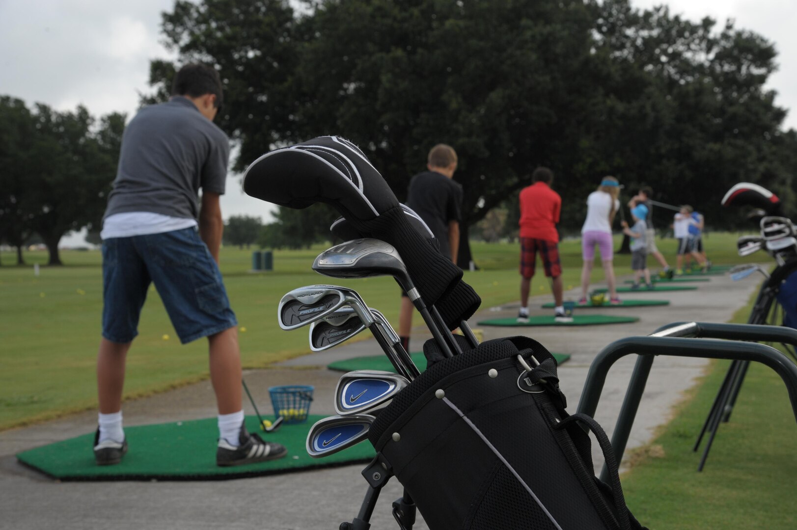 Children practice their golf swings at the Randolph Oak Golf Course driving range during the Junior Golf Camp, June 14, 2016, at Joint Base San Antonio-Randolph. Thirty-six children, ages 7 to 14, took four days of lessons from volunteer instructors and played a few holes on the course on the last day of the camp. 