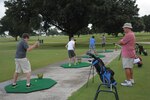 Brian Cannon, golf instructor, oversees students golf swings at the driving range, during the Junior Golf Camp, June 14, 2016 at Joint Base San Antonio-Randolph.  Golf camp was devoted to lessons on chipping, putting and hitting. Camp instructors taught the young golfers a variety of basic golf skills, including the proper mechanics for holding and swinging a club and iron, hitting, chipping and putting, the rules of golf, golf safety and etiquette and sportsmanship.