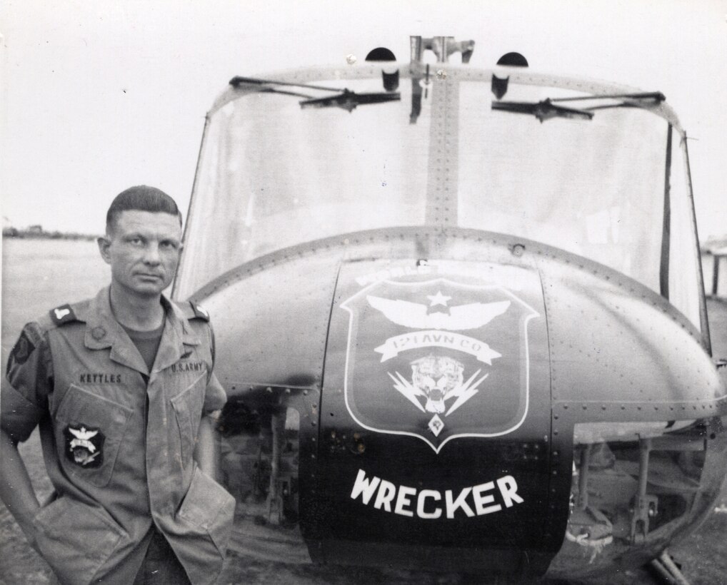 Then-Army Maj. Charles Kettles stands in front of a 121st Aviation Company UH-1H Huey helicopter during his second tour of duty in Vietnam in 1969. For heroic actions in May 1967 during his first tour in Vietnam, Kettles will receive the Medal of Honor from President Barack Obama in a White House ceremony July 18, 2016. Courtesy photo