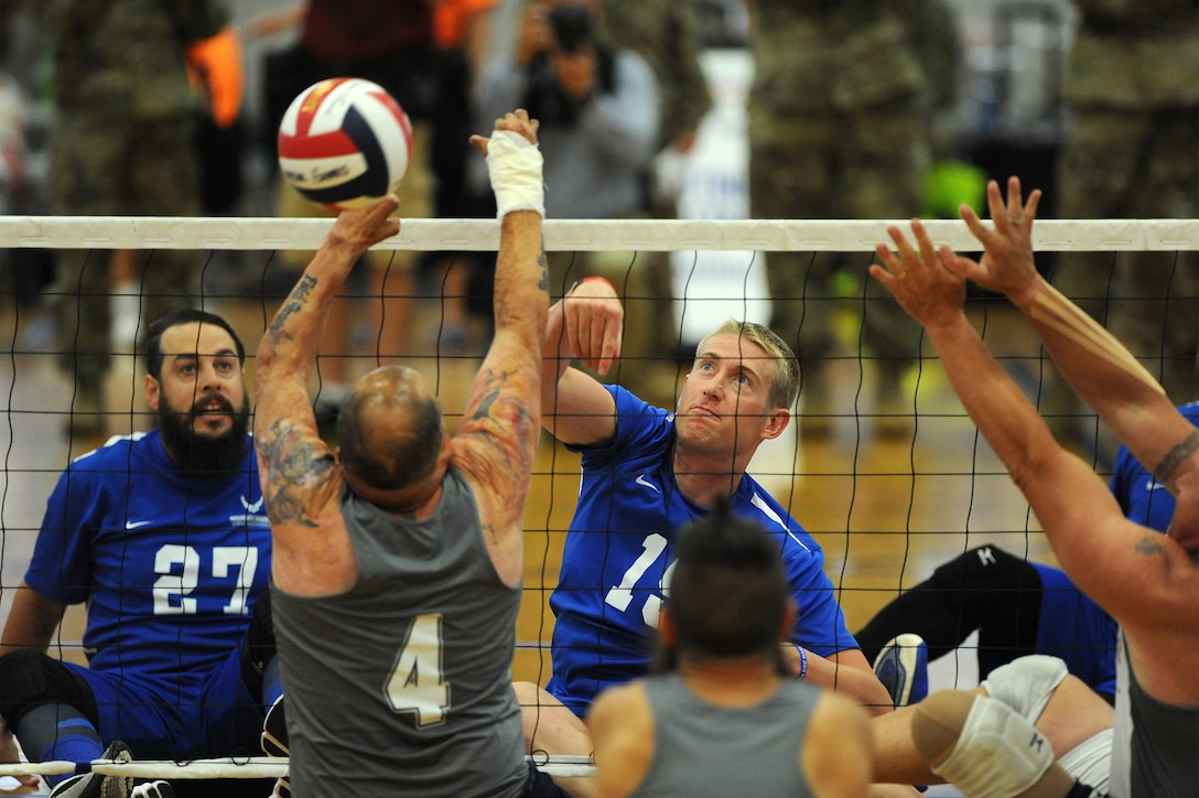 Air Force Capt. Michael Gentry, center right, spikes the ball during the sitting volleyball gold medal match of the 2016 Department of Defense Warrior Games at the U.S. Military Academy in West Point, N.Y., June 21, 2016. Air Force photo by Tech. Sgt. Steve Grever