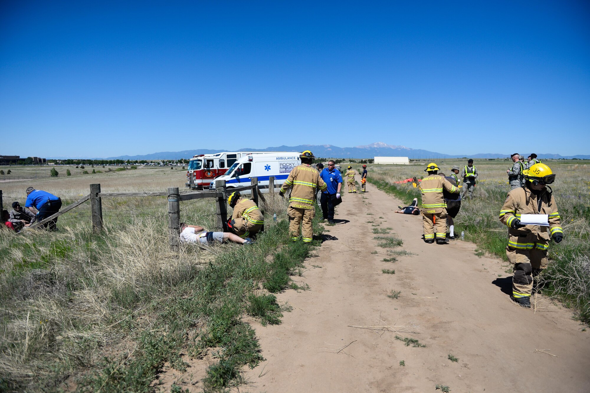 First responders tend to victims and survey the damaged areas during a tornado exercise at Schriever Air Force Base, Colorado, Wednesday, June 15, 2016. The tornado was just one of the scenarios Schriever personnel responded to during the base-wide exercise June 6 – 16. (U.S. Air Force photo/Christopher DeWitt)