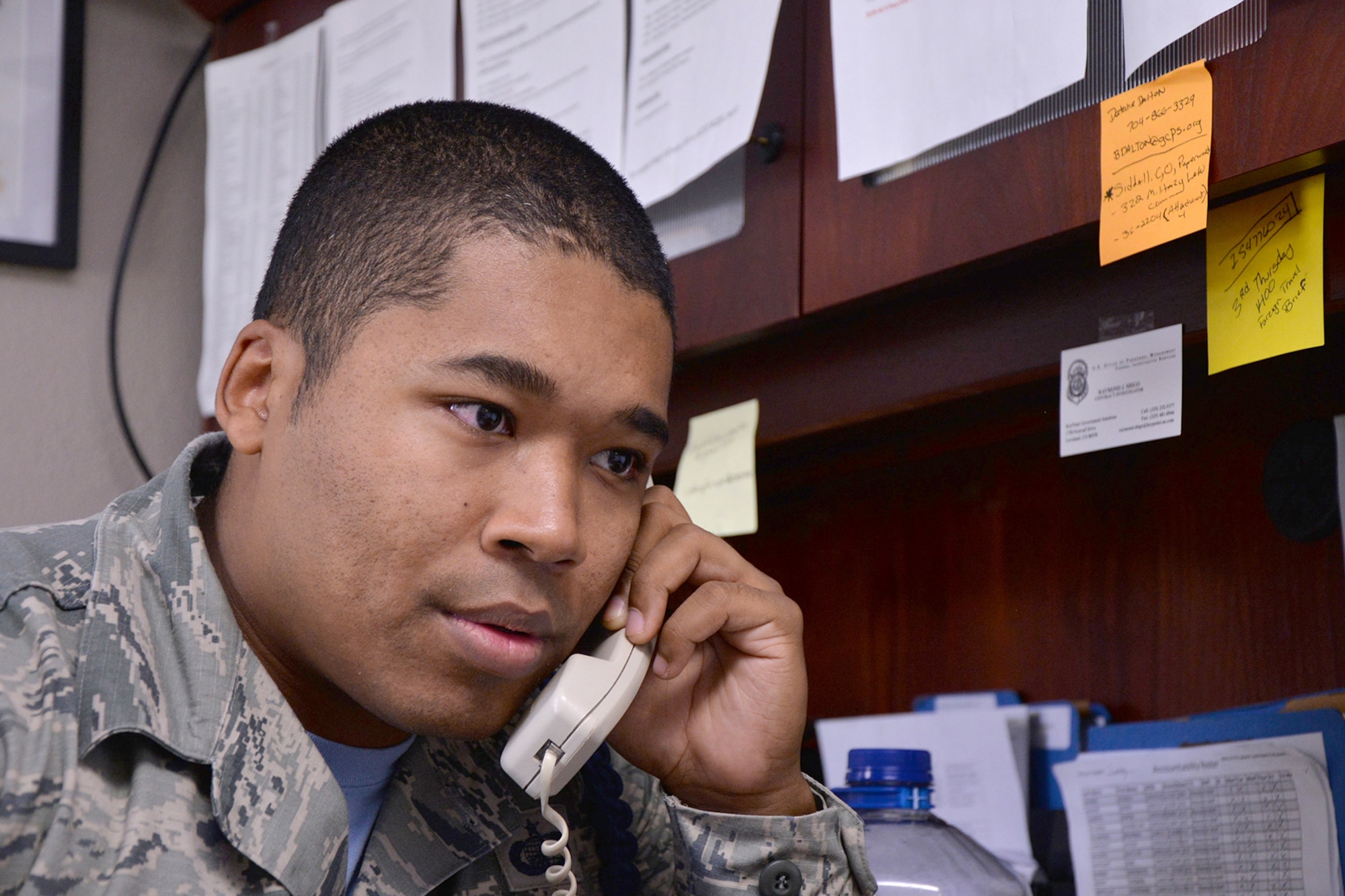 U.S. Air Force Tech. Sgt. Christopher Henry IV, 316th Training Squadron Military Training Leader, speaks on the phone on Goodfellow Air Force Base, Texas, June 17, 2016. MTLs are tasked to help students meet military regulations and pass their classes. (U.S. Air Force photo by Airman 1st Class Randall Moose/Released)