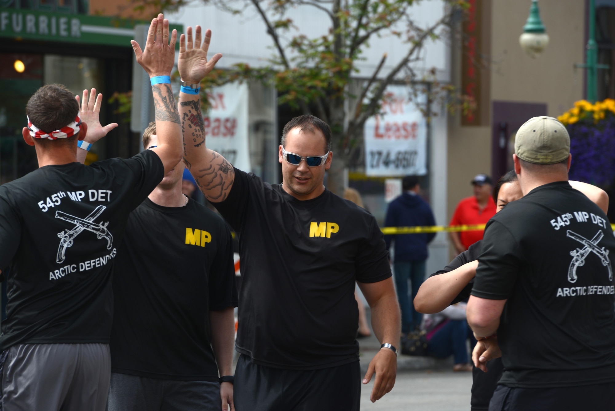 The ‘Arctic Defenders,’ of the 545th Military Police Company, takes first place in the Hero Games during the Downtown Summer Solstice Festival in Anchorage, Alaska, June 18, 2016. The Hero Games is a friendly competition between Alaska’s first responders with challenges that require balance, strength and teamwork. (U.S. Air Force photo Airman 1st Class Christopher R. Morales)