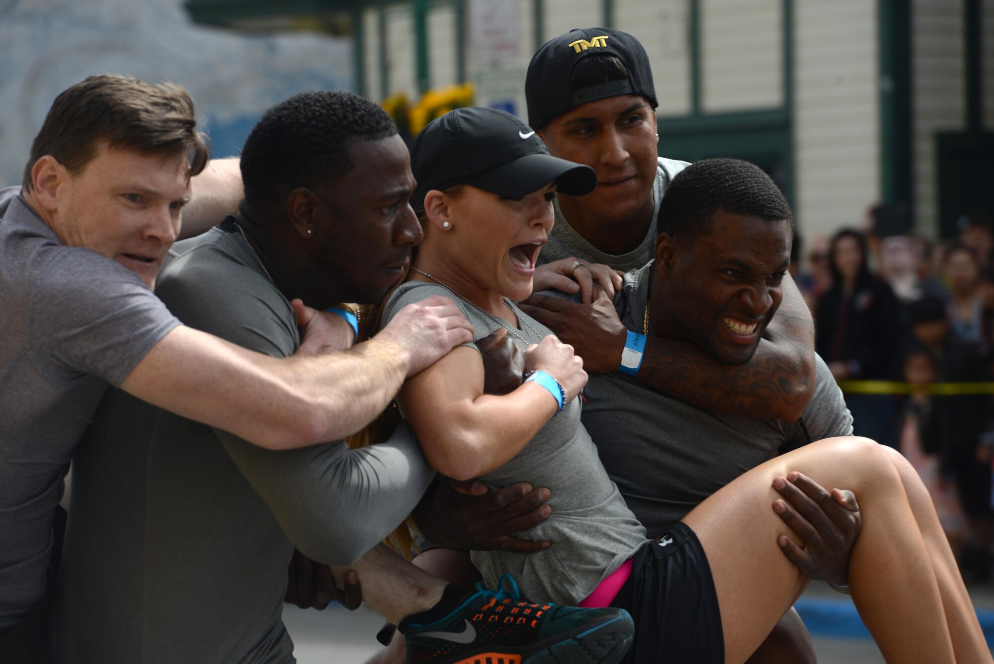 Five members of the ‘The Bios,’ from the Joint Base Elmendorf-Richardson Hospital, perform a body carry as part of the Hero Games during the Downtown Summer Solstice Festival in Anchorage, Alaska, June 18, 2016. The four-part relay consisted of sprinting, weaving through cones, hula-hooping and the infamous body carry. The Hero Games is a friendly competition between Alaska’s first responders with challenges that require balance, strength and teamwork. (U.S. Air Force photo Airman 1st Class Christopher R. Morales)