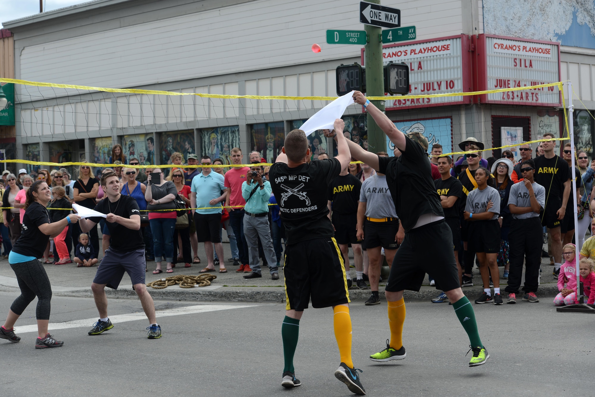The ‘Arctic Defenders,’ of the 545th Military Police Company, ‘serves’ in a game of water balloon volleyball against the Anchorage Police Department as part of the Hero Games during the Downtown Summer Solstice Festival in Anchorage, Alaska, June 18, 2016. Water balloon volleyball was the final high-stakes challenge where competitors sought the first place title at the risk of being splashed with cold water. The Hero Games is a friendly competition between Alaska’s first responders with challenges that require balance, strength and teamwork. (U.S. Air Force photo Airman 1st Class Christopher R. Morales)