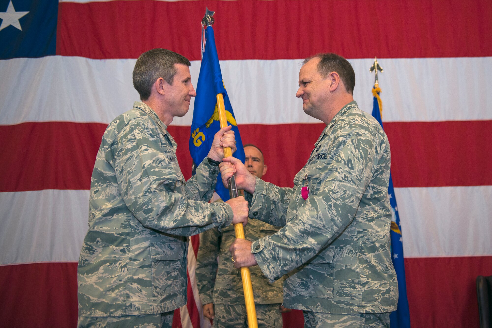 U.S. Air Force Col. Thomas Kunkel, 23d Wing commander, receives the 23d Mission Support Group guidon from Col. Norman Dozier, outgoing 23d MSG commander, during a change of command ceremony, June 21, 2016, at Moody Air Force Base, Ga. Dozier is scheduled to depart to Los Angeles AFB, Calif., to serve as the Space and Missile System Center financial management director.
(U.S. Air Force photo by Airman 1st Class Greg Nash/Released)
