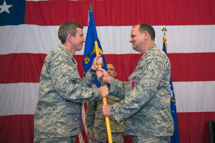 U.S. Air Force Col. Thomas Kunkel, 23d Wing commander, receives the 23d Mission Support Group guidon from Col. Norman Dozier, outgoing 23d MSG commander, during a change of command ceremony, June 21, 2016, at Moody Air Force Base, Ga. Dozier is scheduled to depart to Los Angeles AFB, Calif., to serve as the Space and Missile System Center financial management director.
(U.S. Air Force photo by Airman 1st Class Greg Nash/Released)
