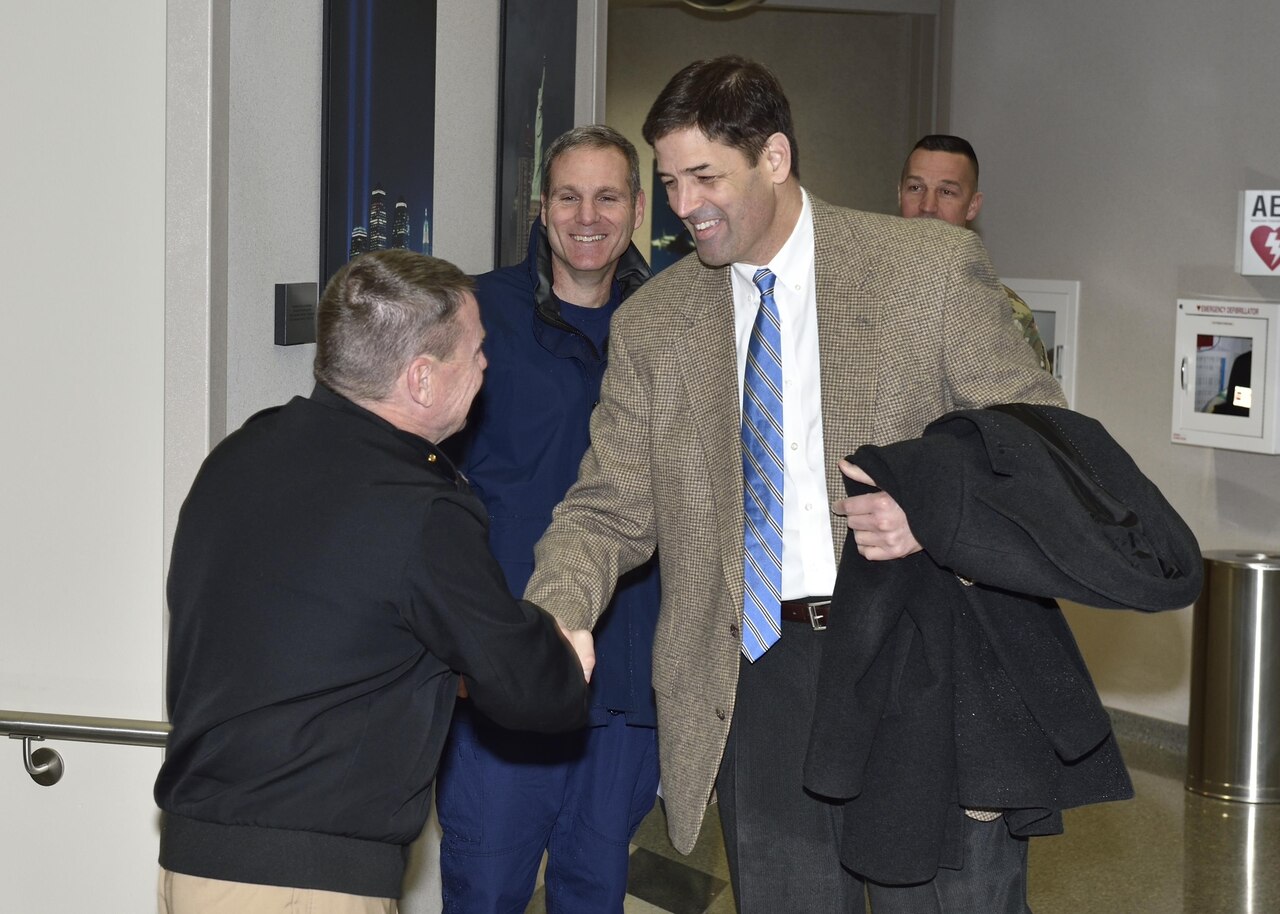 Navy Adm. William E. Gortney, then-commander of the North American Aerospace Defense Command and U.S. Northern Command, greets Thomas Atkin, acting assistant secretary of defense for homeland defense and global security, during a visit to Colorado Springs, Colo., March 23, 2016. During his June 22 testimony before the House Armed Services Committee, Atkin said the department is making progress in implementing its cyber strategy. DoD photo