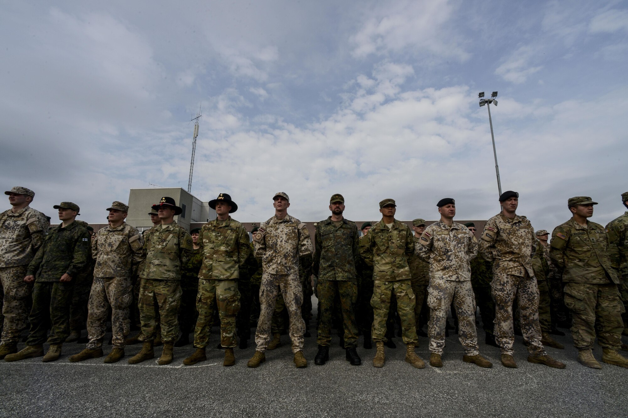 NATO service members stand in formation during a closing ceremony at Tapa Training Base, Estonia, June 21, 2016. U.S. forces in Europe participated in Saber Strike 16; a long-standing, U.S. Joint Chiefs of Staff-directed, U.S. Army Europe-led cooperative-training exercise, which has been conducted annually since 2010. This year’s exercise focused on promoting interoperability with allies and regional partners. The United States has enduring interests in supporting peace and prosperity in Europe and bolstering the strength and vitality of NATO, which is critical to global security. (U.S. Air Force photo/Senior Airman Nicole Keim)