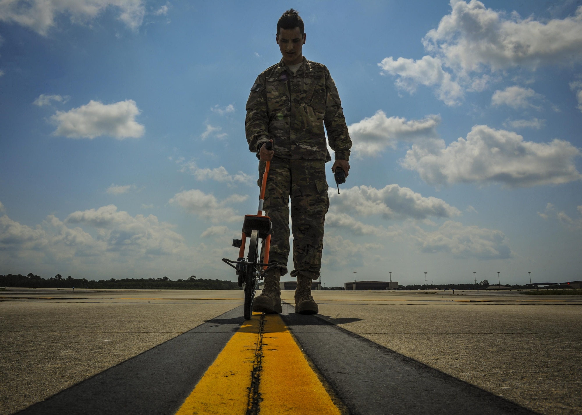 Senior Airman David Rios, an airfield manager with the 1st Special Operations Support Squadron, uses a wheel measurement at Hurlburt Field, Fla., June 17, 2016. Routine airfield checks are performed to inspect and maintain the airfield to prevent any mishaps during aircraft movement. (U.S. Air Force photo by Airman 1st Class Joseph Pick)