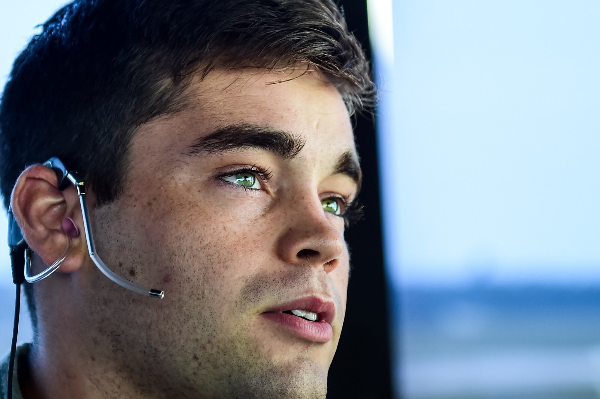 Airman 1st Class Hollis Read, an air traffic control apprentice with the 1st Special Operations Support Squadron, listens to air traffic control communications at Hurlburt Field, Fla., June 17, 2016. Air traffic controllers enable a safe, orderly and expeditious flow of aircraft on the flightline and in the air. (U.S. Air Force photo by Staff Sgt. Christopher Callaway)