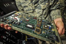 Airman 1st Class Patrick Nunn, an airfield systems technician with the 1st Special Operations Support Squadron, examines a circuit board at Hurlburt Field, Fla., June 17, 2016. Airfield systems technicians install, remove and maintain navigation and air traffic control ground-to-air radio systems. (U.S. Air Force photo by Airman 1st Class Joseph Pick)