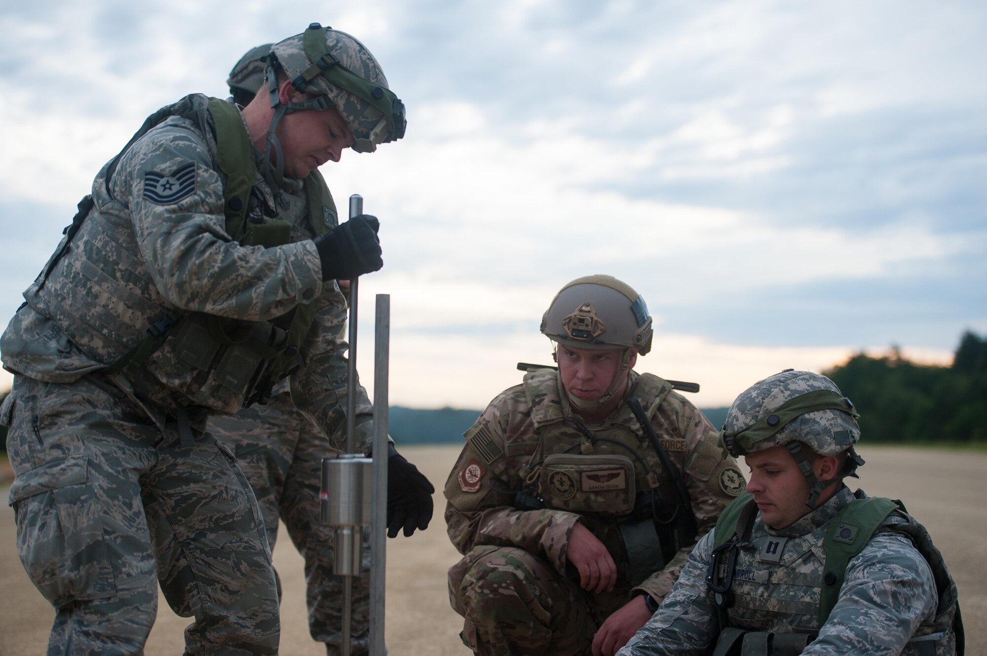 U.S. Air Force Maj. Aaron Cook, 621st Mobility Support Operations Squadron Air Mobility Liaison Officer to the 2nd Cavalry Regiment/Joint Multinational Training Center, works with an Airfield Assessment Team from the 821st Contingency Response Group during Exercise Swift Response 16 at Hohenfels Training Area, Germany, June 16, 2016. Exercise SR16 is one of the premier military crisis response training events for multinational airborne forces in the world, the exercise has more than 5,000 participants from 10 NATO nations. (U.S. Air Force photo by Master Sgt. Joseph Swafford/Released) 