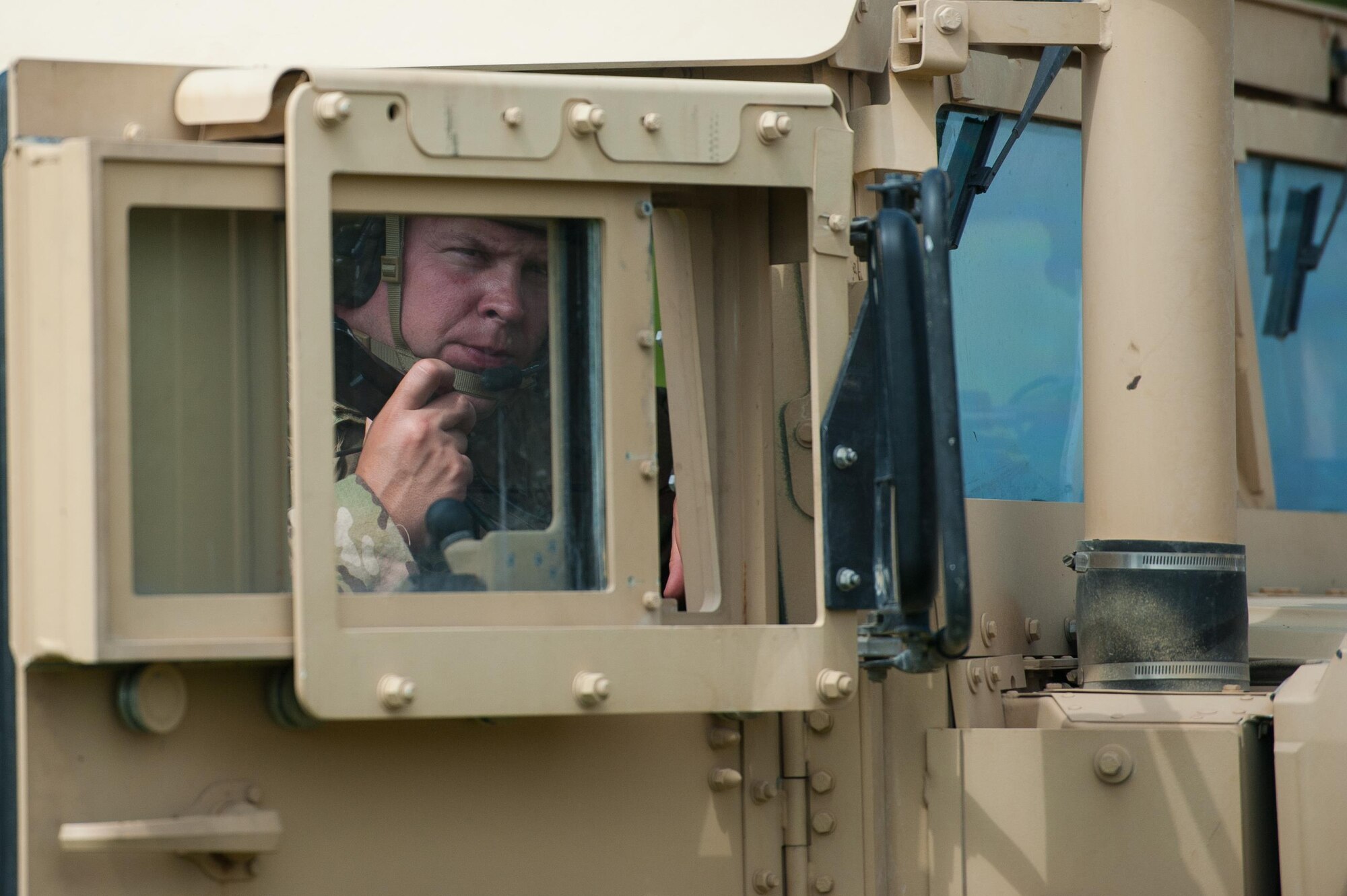 Maj. Aaron Cook, 621st Mobility Support Operations Squadron Air Mobility Liaison Officer to the 2nd Cavalry Regiment/Joint Multinational Training Center, advise an U.S. Air Force C-130J Super Hercules pilot during Exercise Swift Response 16 at Hohenfels Training Area, Germany, June 16, 2016. Exercise SR16 is one of the premier military crisis response training events for multinational airborne forces in the world, the exercise has more than 5,000 participants from 10 NATO nations. (U.S. Air Force photo by Master Sgt. Joseph Swafford/Released) 