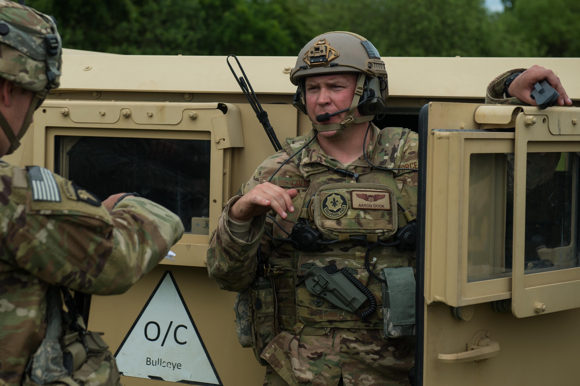 U.S. Air Force Maj. Aaron Cook, 621st Mobility Support Operations Squadron Air Mobility Liaison Officer to the 2nd Cavalry Regiment/Joint Multinational Training Center, speaks with a Soldier assigned to the 82nd Airborne Division during Exercise Swift Response 16 at Hohenfels Training Area, Germany, June 16, 2016. Exercise SR16 is one of the premier military crisis response training events for multinational airborne forces in the world, the exercise has more than 5,000 participants from 10 NATO nations. (U.S. Air Force photo by Master Sgt. Joseph Swafford/Released) 