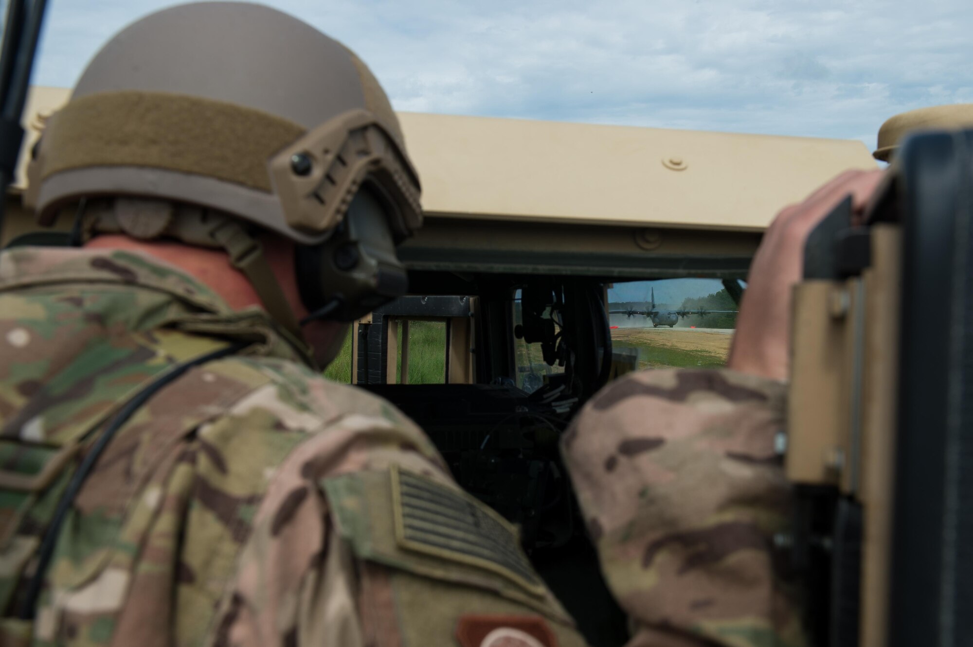 U.S. Air Force Maj. Aaron Cook, 621st Mobility Support Operations Squadron Air Mobility Liaison Officer to the 2nd Cavalry Regiment/Joint Multinational Training Center, looks on as a U.S. Air Force C-130J Super Hercules aircraft lands during Exercise Swift Response 16 at Hohenfels Training Area, Germany, June 16, 2016. Exercise SR16 is one of the premier military crisis response training events for multinational airborne forces in the world, the exercise has more than 5,000 participants from 10 NATO nations. (U.S. Air Force photo by Master Sgt. Joseph Swafford/Released) 