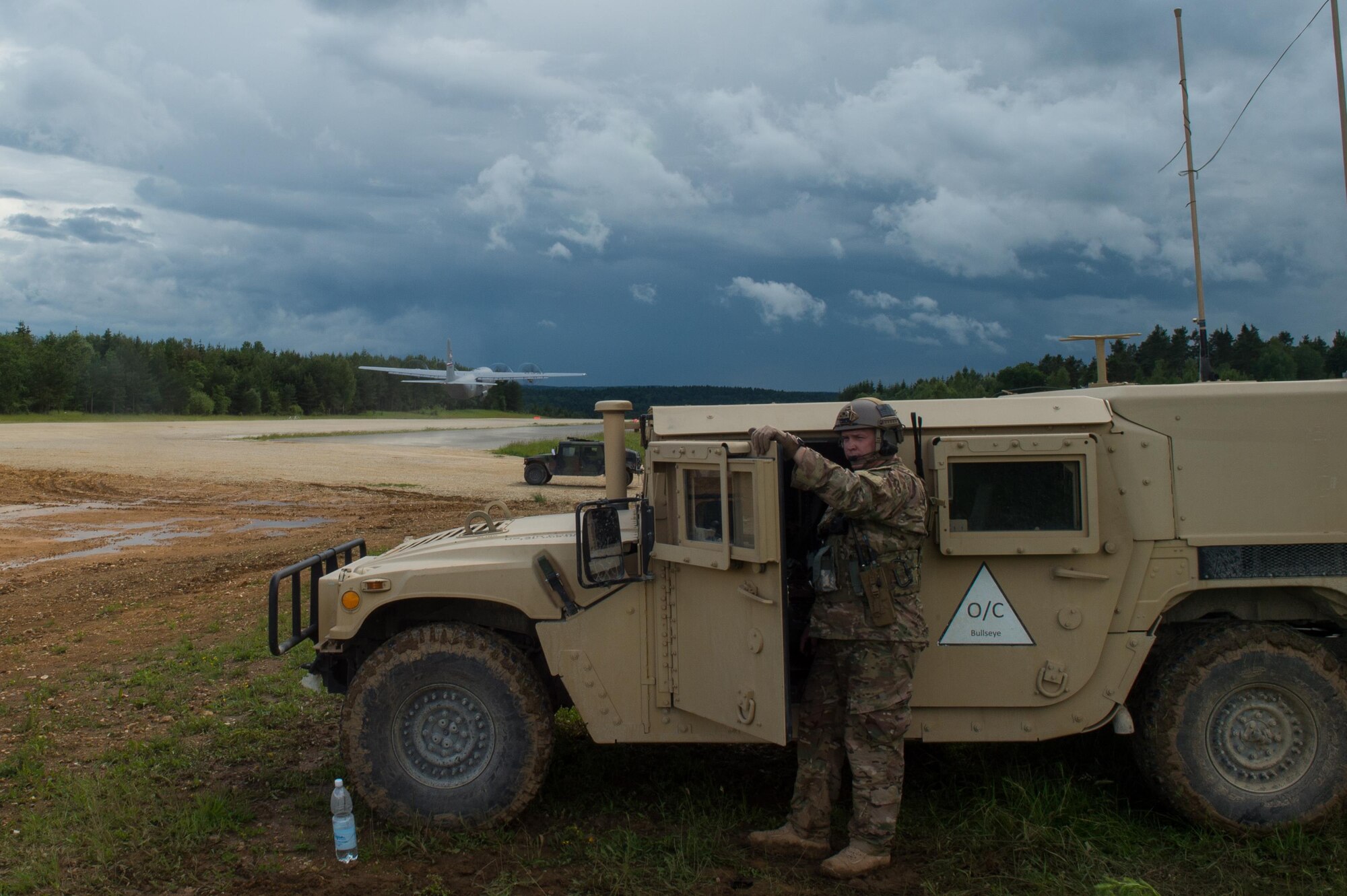 U.S. Air Force Maj. Aaron Cook, 621st Mobility Support Operations Squadron Air Mobility Liaison Officer to the 2nd Cavalry Regiment/Joint Multinational Training Center, looks on as a U.S. Air Force C-130J Super Hercules aircraft from Dyess Air Force Base, Texas takes off during Exercise Swift Response 16 at Hohenfels Training Area, Germany, June 17, 2016. Exercise SR16 is one of the premier military crisis response training events for multinational airborne forces in the world, the exercise has more than 5,000 participants from 10 NATO nations. (U.S. Air Force photo by Master Sgt. Joseph Swafford/Released) 