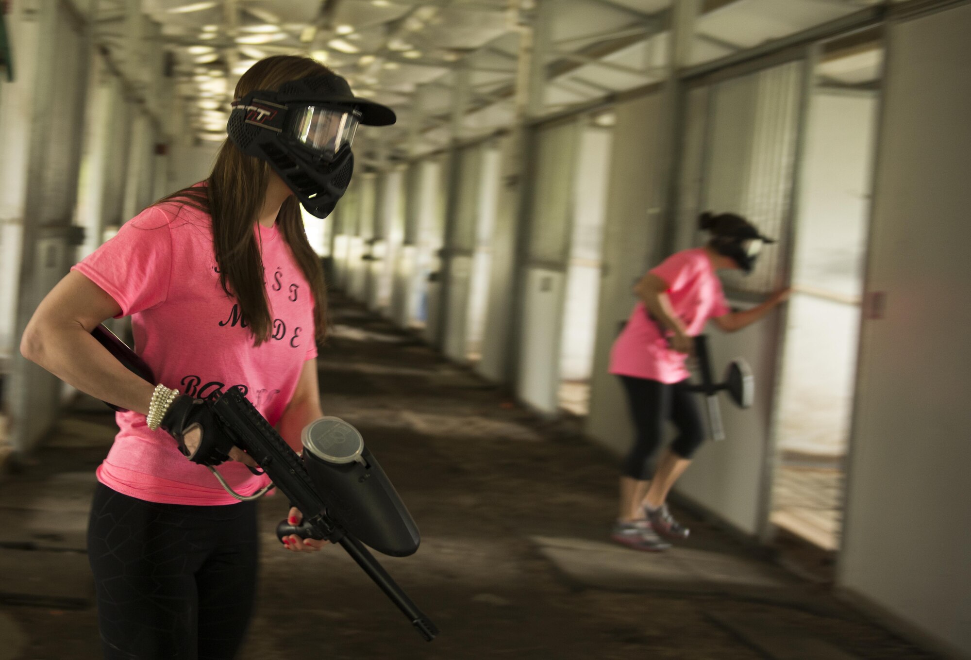 Air Force Staff Sgt. Heidi Wacker, 673d Medical Group, Mental Health flight, mental health technician, checks the interior of an old stable for targets as they progress through their first Dirty Dozen challenge June 10. Dirty Dozen is a chain of 12 stations, each testing the team's competency in intellectual and physical challenges. (U.S. Air Force photo by Senior Airman Kyle Johnson)