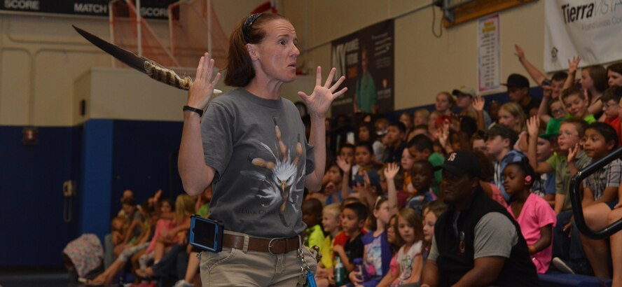 Melissa Tofflemower, a raptor educator, teaches children about the wingspan of the birds during HawkQuest’s raptor demonstration at Schriever Air Force Base, Colorado, Tuesday, June 21, 2016. Children learned the difference between each bird’s wingspan, hunting traits and other unique characteristics. (U.S. Air Force photo/Airman William Tracy)