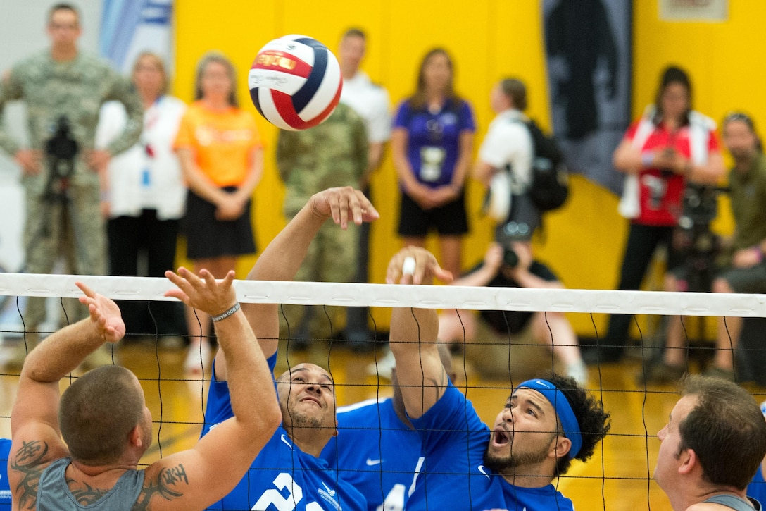 Air Force Tech Sgt. Brian Williams, left, and Air Force veteran Staff Sgt. Sven Perryman return a volley during the sitting volleyball gold medal round in the 2016 Department of Defense Warrior Games at the U.S. Military Academy in West Point, N.Y., June 21, 2016. DoD photo by EJ Hersom