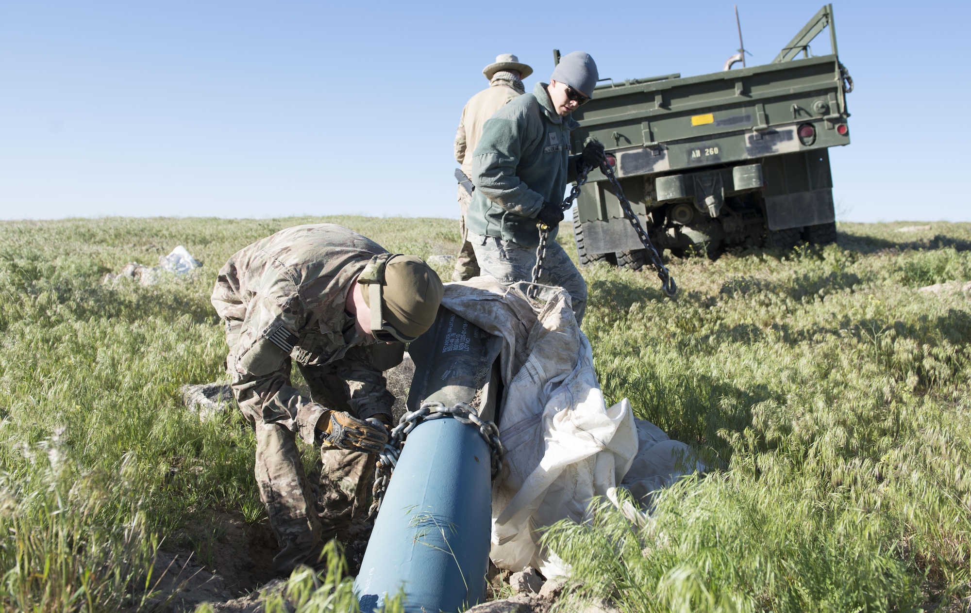 Explosive ordnance disposal members from the 366th Civil Engineer Squadron prepare for an inert GBU-12 Paveway II extraction during a range clearance at Saylor Creek Range Complex, Idaho, May 9, 2016. The training range's impact areas consist of approximately 24,000 acres of exclusive use area land. The ranges provide aircrews a realistic layout of simulated targets similar to those they might encounter during actual combat, such as an airfield, an industrial complex and radar, missile, gun and artillery sites. (U.S. Air Force photo by Airman 1st Class Chester Mientkiewicz/Released)