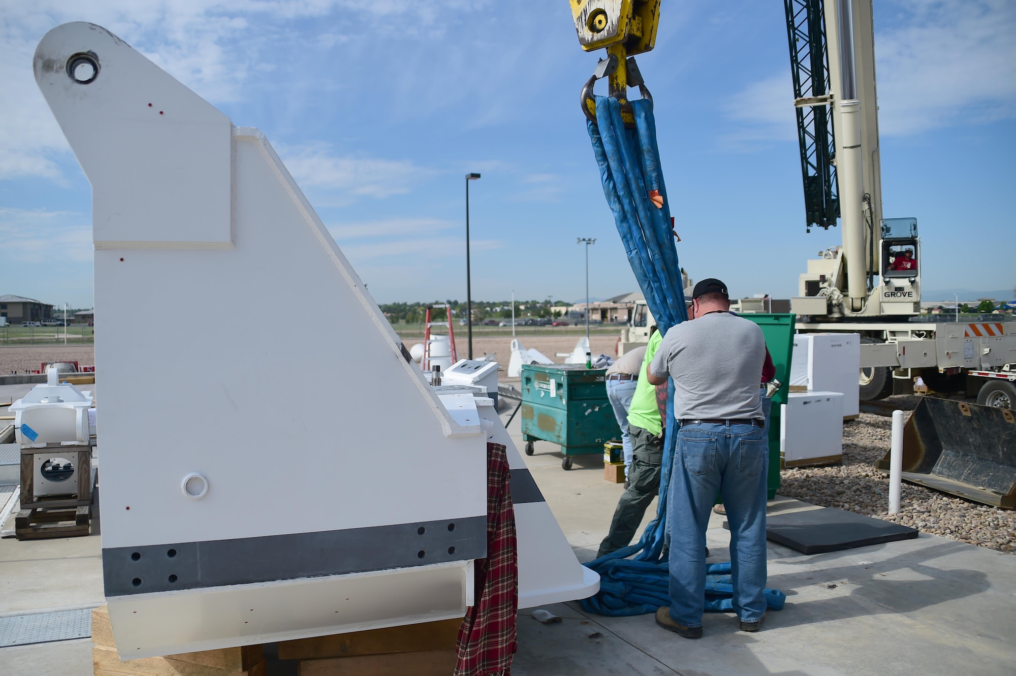 Construction workers detach a piece of the new terminal from a crane June 6, 2016, on Buckley Air Force Base, Colo. The construction crew is working to install a new terminal which is a part of the Modernization of Earth Terminals project. (U.S. Air Force photo by Airman 1st Class Luke W. Nowakowski/Released)