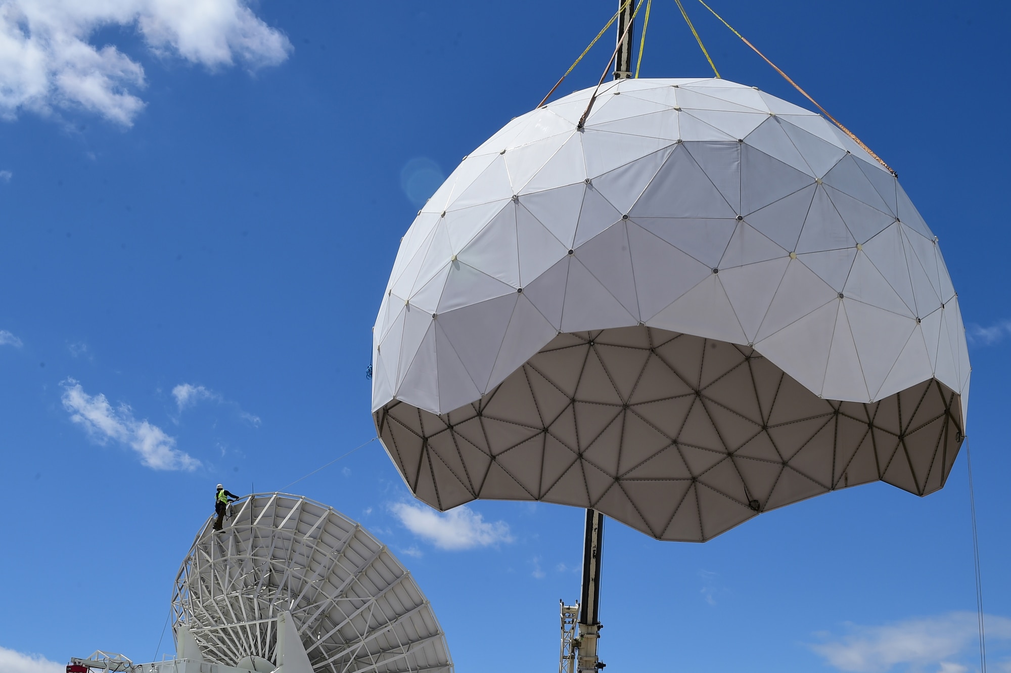 A construction crew removes a protective radome April 27, 2016, on Buckley Air Force Base, Colo. The Modernization of Earth Terminals project has begun at Buckley in order to install terminals that are technologically compatible with the satellites they transmit too. (U.S. Air Force photo by Airman 1st Class Luke W. Nowakowski/Released)