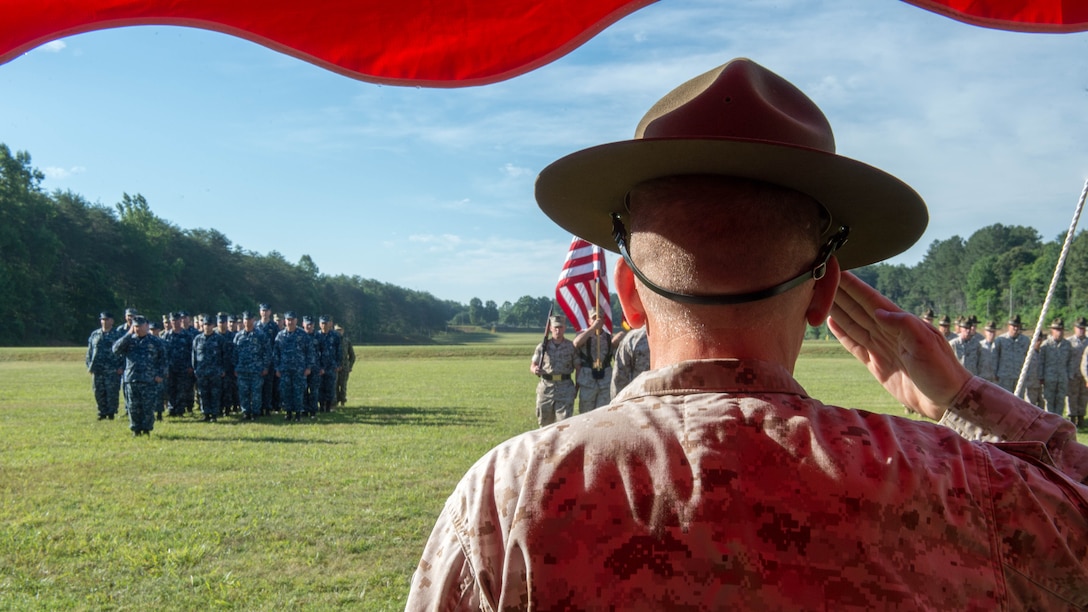 U.S. Marine Corps Col. Gregory Kitchens renders a salute as the ceremonial platoon marches on the colors during the opening ceremony for the 55th annual Interservice Rifle Championship at Range 4, Weapons Training Battalion, Marine Corps Base Quantico, Virginia, June 22, 2016. The  competition was recognized and endorsed in 1960 and has participants from all branches of the military. 