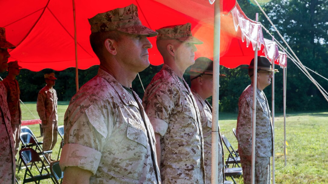 Members of the official party stand at attention while colors are being presented during the opening ceremony for the 55th annual Interservice Rifle Championship at Range 4, Weapons Training Battalion, Marine Corps Base Quantico, Virginia, June 22, 2016. The competition was recognized and endorsed in 1960 and has participants from all branches of the military. 