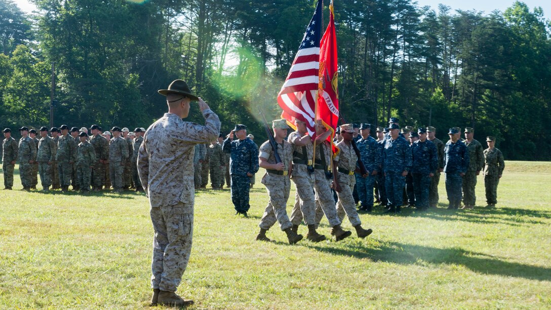 A color guard passes by the competitors of the 55th annual Interservice Rifle Championship during the opening ceremony at Range 4, Weapons Training Battalion, Marine Corps Base Quantico, Virginia, June 22, 2016. The  competition was recognized and endorsed in 1960 and has participants from all branches of the military. 