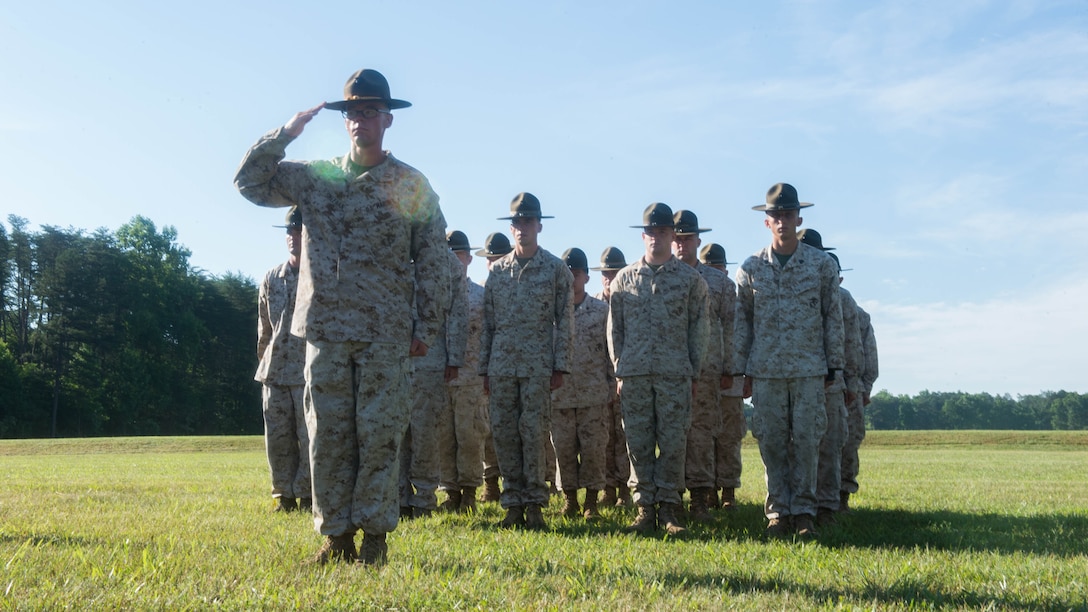 U.S. Marine Corps Rifle Team stands at attention as colors are presented during the opening ceremony for the 55th annual Interservice Rifle Championship at Range 4, Weapons Training Battalion, Marine Corps Base Quantico, Virginia, June 22, 2016. The competition was recognized and endorsed in 1960 and has participants from all branches of the military. 