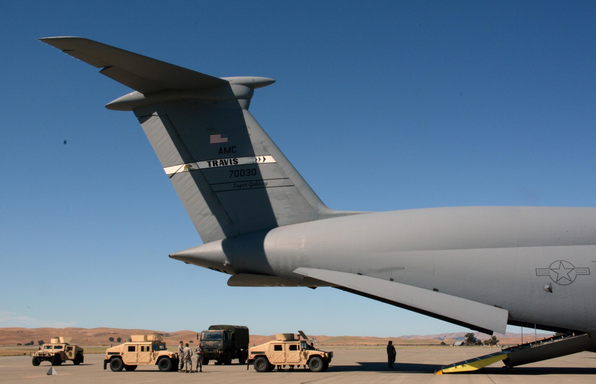 Port dawgs from the 45th, 55th, and 82nd Aerial Port Squadrons train securing Humvees and Light Medium Tactical Vehicles to a C-5 Galaxy June 18, 2016 on Travis Air Force Base. (U.S. Air Force photos/Staff Sgt. Madelyn Brown)