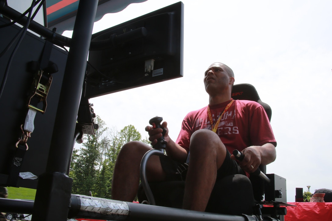 Kenard Booker takes off in a flight simulator at the National Museum of the Marine Corps as part of the 2016 Key Leaders and Educators Workshop in Triangle, Va., June 22. The workshop includes events such as infantry patrolling, flying in an MV-22 Osprey and more. The event also creates a mutually beneficial relationship between educators and the Marine Corps where key leaders and educators can share knowledge on the Corps based on firsthand experience to their students who show interest in officer programs. Brooker is a TRiO Pre-College Programs Director for North Dakota State University, Fargo, ND. 