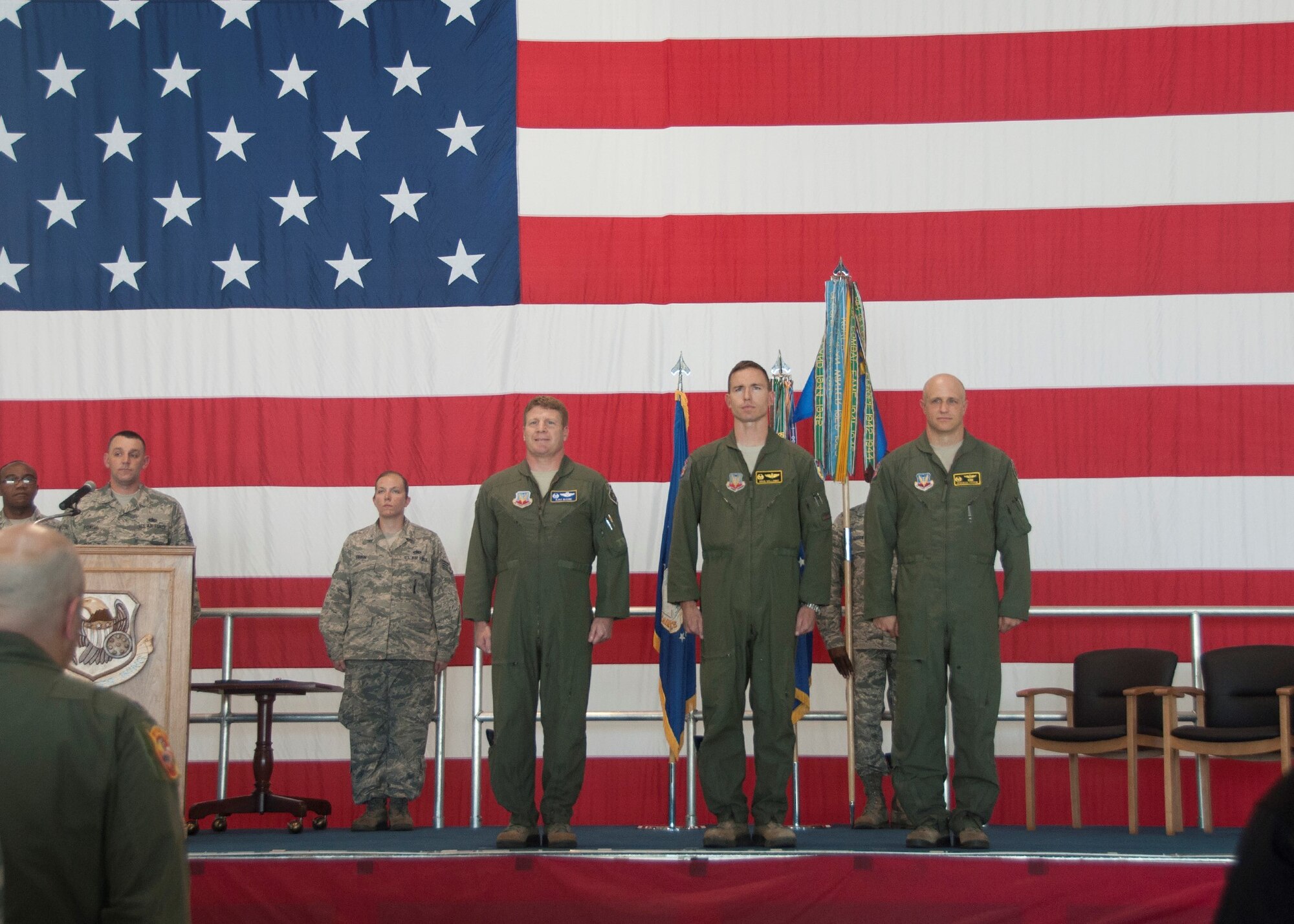 Col. James McCune, 495th Fighter Group commander, left, Lt. Col. John Galloway, Jr., 358th Fighter Squadron outgoing commander, and Maj. Jeremiah Parvin, 358th Fighter Squadron new commander, stand at attention during the change of command ceremony in the A-10 hangar at Whiteman Air Force Base, June 21, 2016. Nearly 100 Airmen, from maintainers to pilots, train and support the 358 FS, an active duty component attached to the 442d Fighter Wing. (U.S. Air Force photo by Senior Airman Missy Sterling/Released) 