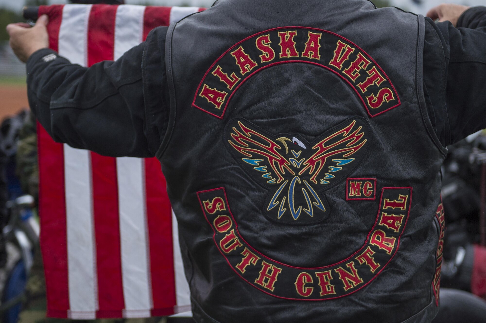 A member of the Alaska Vets Motorcycle Club gets a flag ready for a ceremony during the Anchorage Bucs Military Appreciation Game at Mulcahy Stadium in Anchorage, Alaska, June 19, 2016. (U.S. Air Force photo by Senior Airman James Richardson/Released)